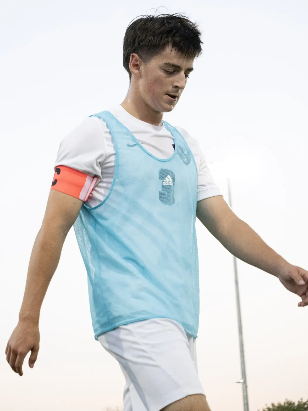 Soccer captain walking along the sideline before play